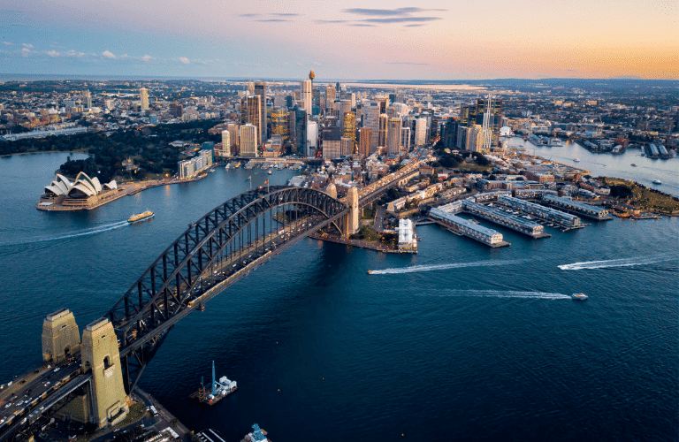 a bridge over water with a city in the background